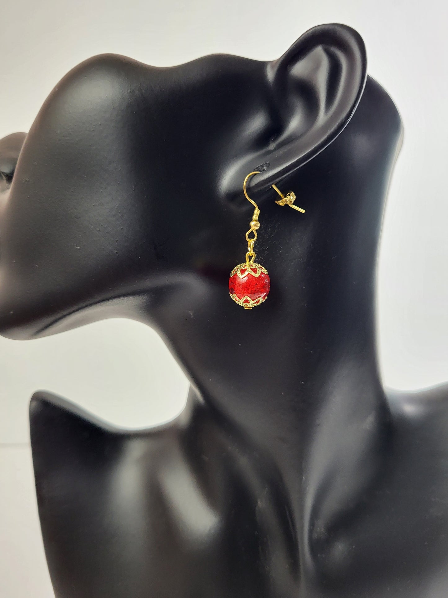 Introducing Ruby Droplet Earrings – a striking blend of passion and elegance that adds a touch of glamour to your ensemble. These exquisite earrings feature captivating red glass beads, each carefully crafted to resemble a radiant ruby. The rich red hue, coupled with delicate gold accents, creates a dazzling combination that is both bold and timeless.