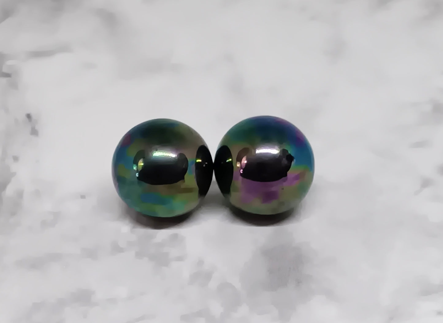These dark orb stud earrings are perfect for those sensitive to metal, but that doesn't mean they're boring. Made from Titanium, these studs will not only make a statement, but they'll also help you feel more comfortable in your own skin.  Contains: One pair of earrings Titanium ear post Handmade in Ocala, FL  Size 7/16in/12mm