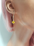 Earrings on Model: The earrings worn by a model, highlighting their length and sparkle.