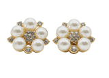 Pair of pearl earrings with gold accents on a white background