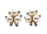 Pair of pearl earrings with gold accents on a white background