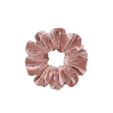 Pink velvet scrunchie on a white background