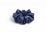 Navy blue scrunchie on a white background