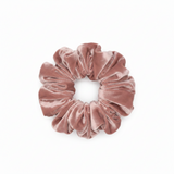 a front view of a pink velour scrunchie