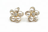 Gold brooch with pearls on a white background