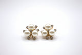 A closeup of 3 faux pearl earrings with rhinestones