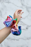 a xxl colorful scrunchie around a wrist