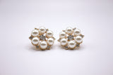 a closeup of a faux pearl cluster earrings with rhinestones